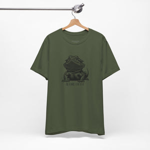 Before Coffee Bearded Dragon Green t-shirt with a graphic design on a hanger against a white background