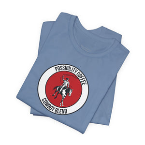 Cowboy Coffee Folded blue t-shirt with a red and white logo on a white background