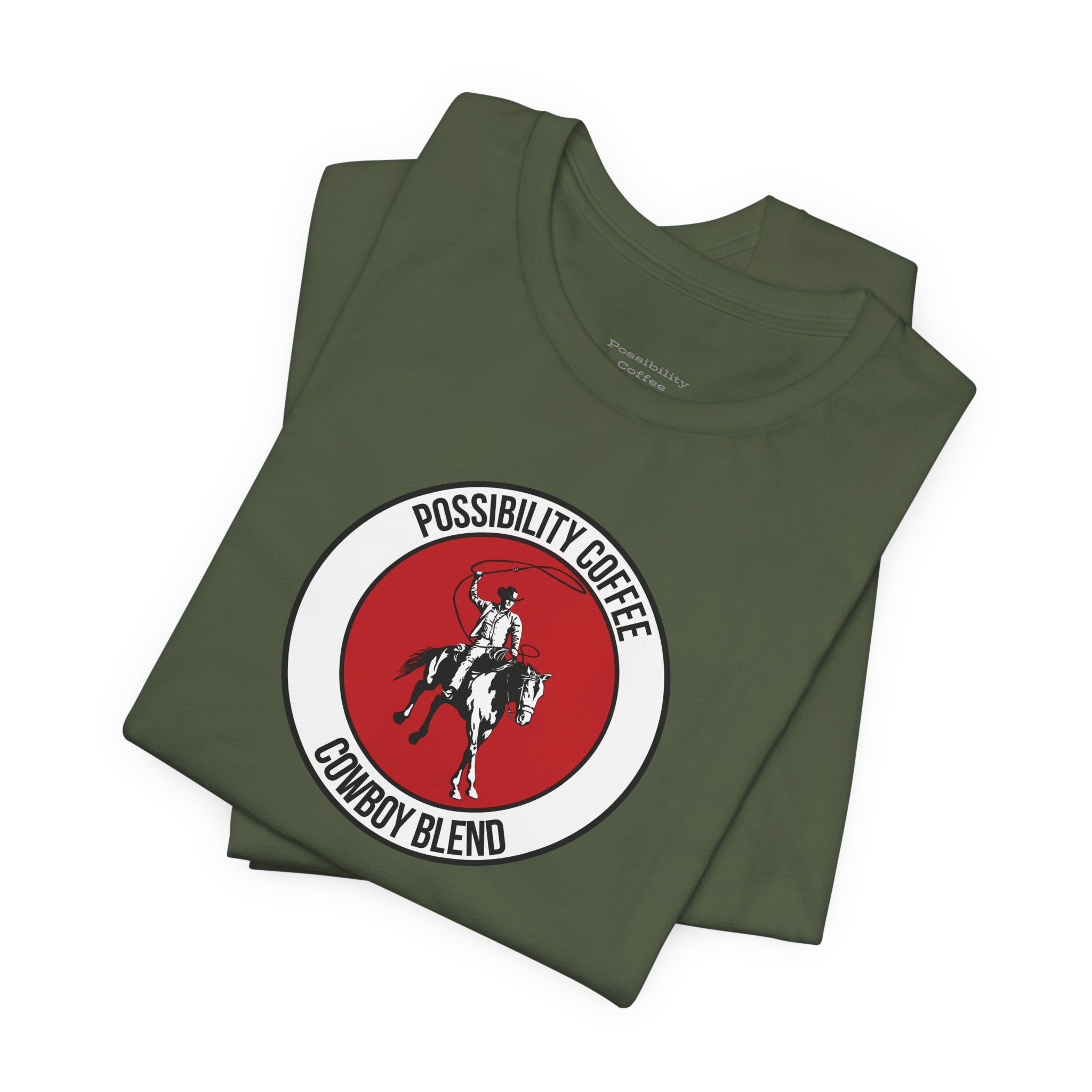 Cowboy Coffee Stack of green t-shirts with a red and white logo on a white background