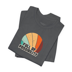 Stack of gray t-shirts with a colorful design and 'Full of Possibility' text on a white background