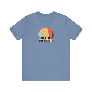 Blue t-shirt with colorful design and 'Full of Possibility' text on a white background