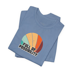 Folded blue t-shirt with 'Full of Possibility' graphic on a white background