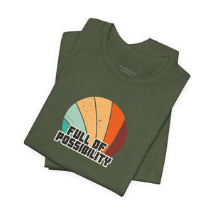Stack of green t-shirts with a colorful graphic and 'Full of Possibility' text on a white background