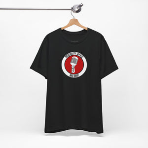 Mic Drop Black t-shirt with a red and white graphic on a hanger against a white background
