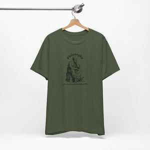 Green t-shirt with design on a hanger against a white background