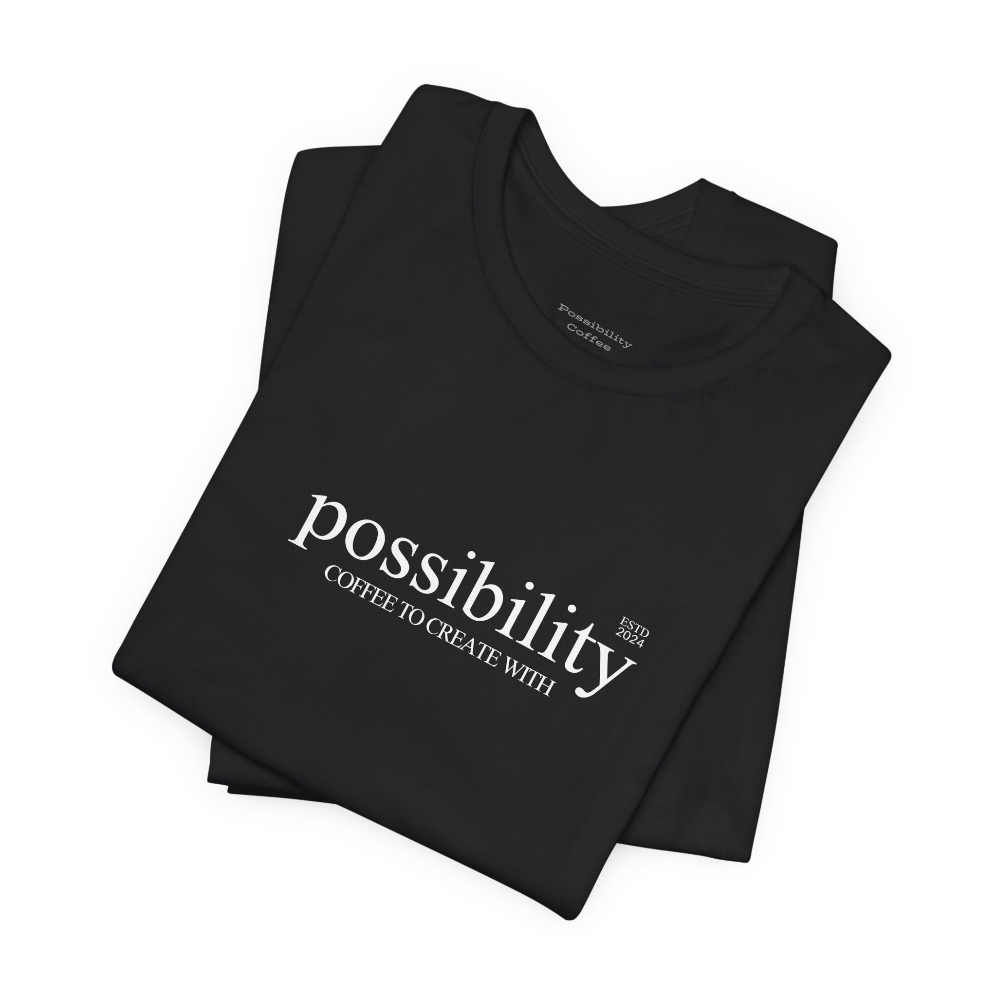 Black t-shirt with 'possibility coffee to create with' text on a white background