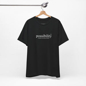 Black t-shirt with 'possibility' text on a hanger against a white background