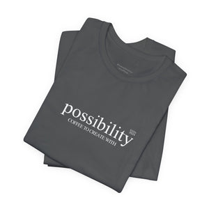 Stack of folded gray t-shirts with 'possibility' text on a white background
