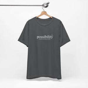 Gray t-shirt with 'possibility' text on a hanger against a white background