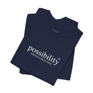 Folded navy blue t-shirt with 'possibility' text on a white background