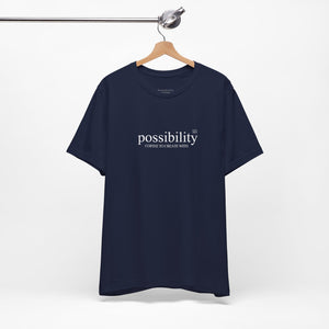 Navy blue t-shirt with 'possibility' text on a hanger against a white background