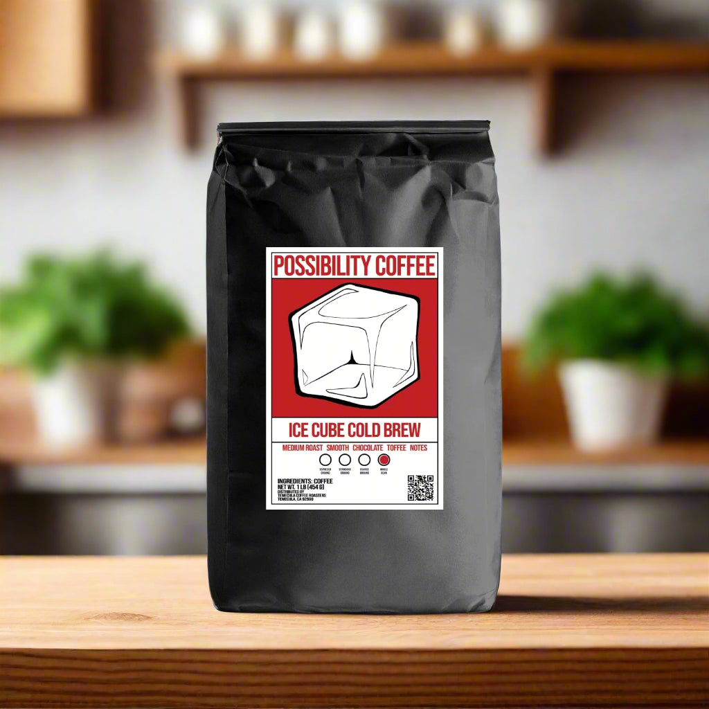 A bag of Possibility Iced Cube Cold Brew Coffee Beans on a wood table in a kitchen