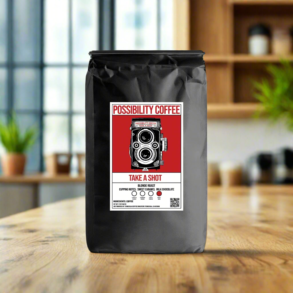 A bag of Possibility Coffee Take a Shot Blonde Espresso with Camera Image on the bag on wood table in a kitchen