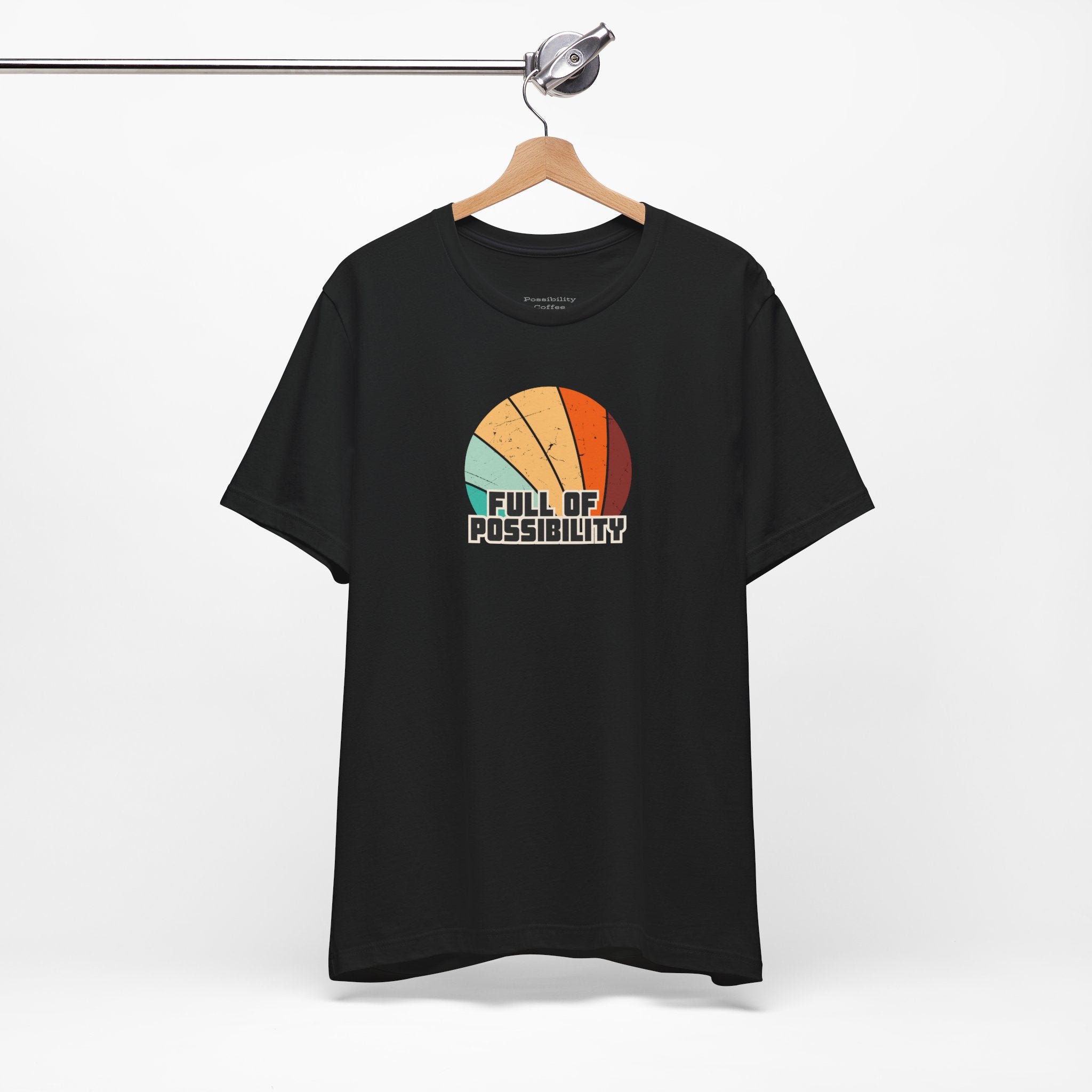 Black t-shirt with colorful design and 'Full of Possibility' text on a white background