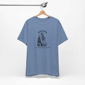 Blue t-shirt with design on a hanger against a white background