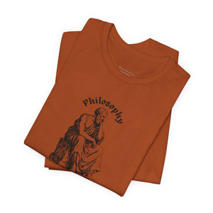 Folded orange t-shirt with design on a white background