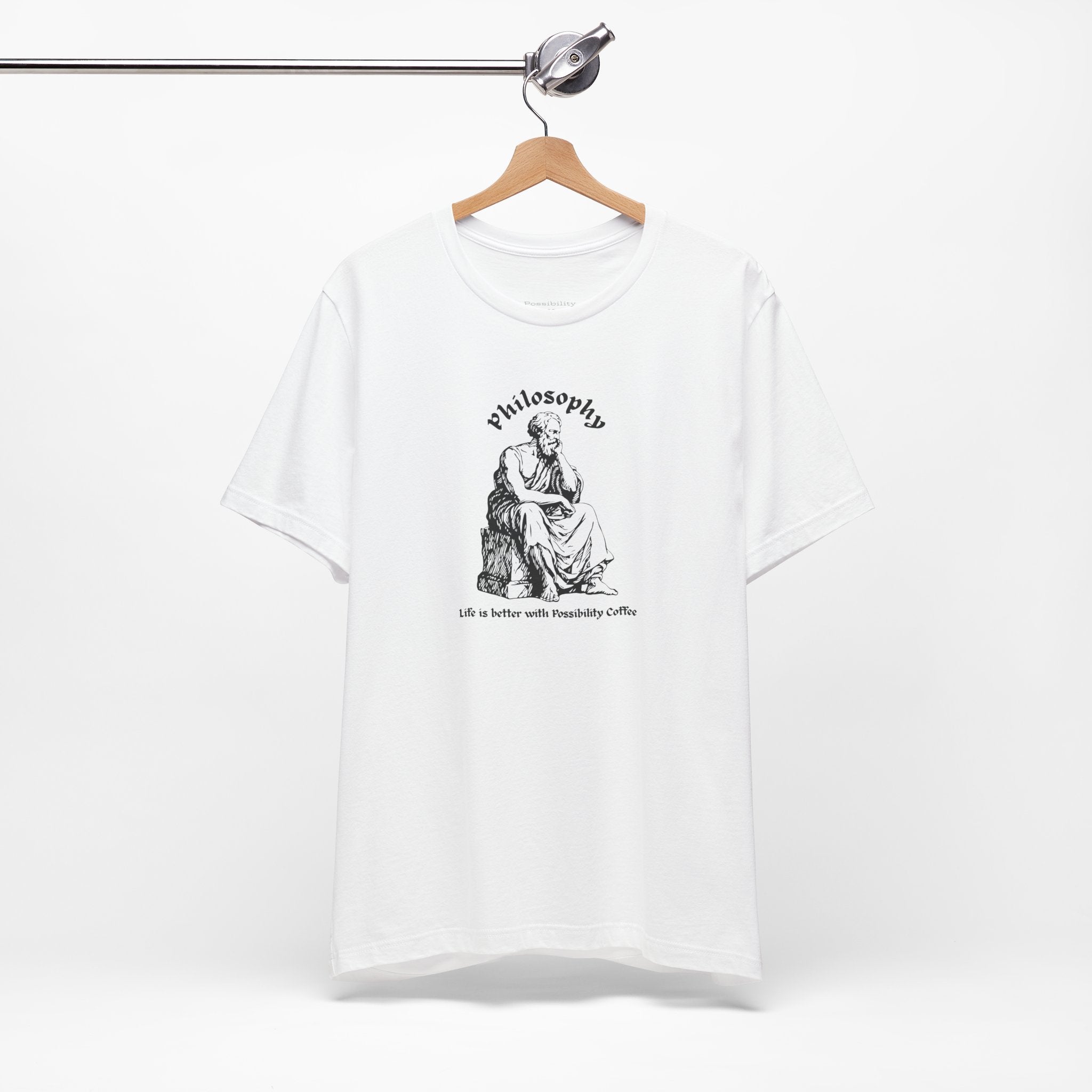 White t-shirt with design on a hanger against a white background