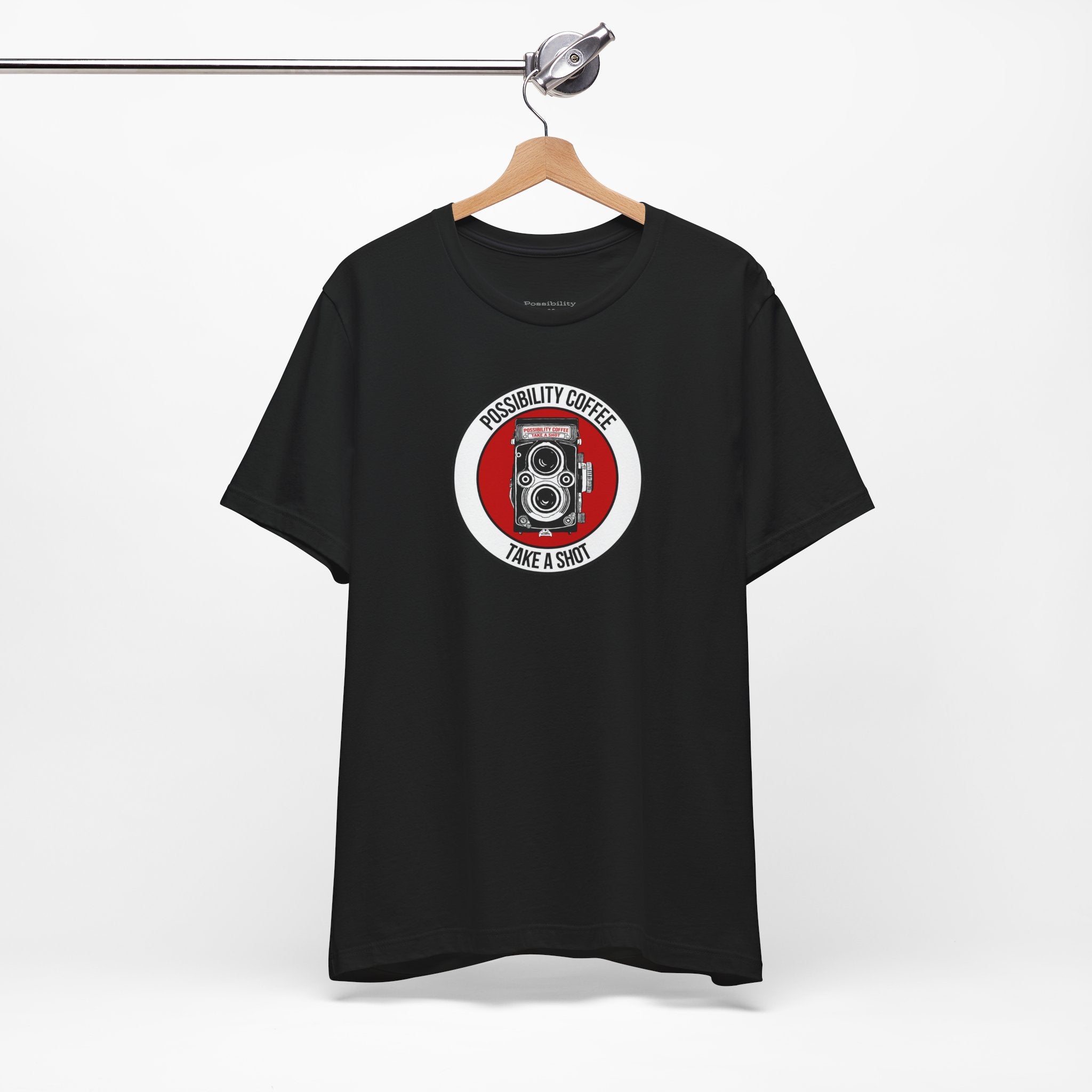 Black t-shirt with a red and white graphic on a hanger against a white background