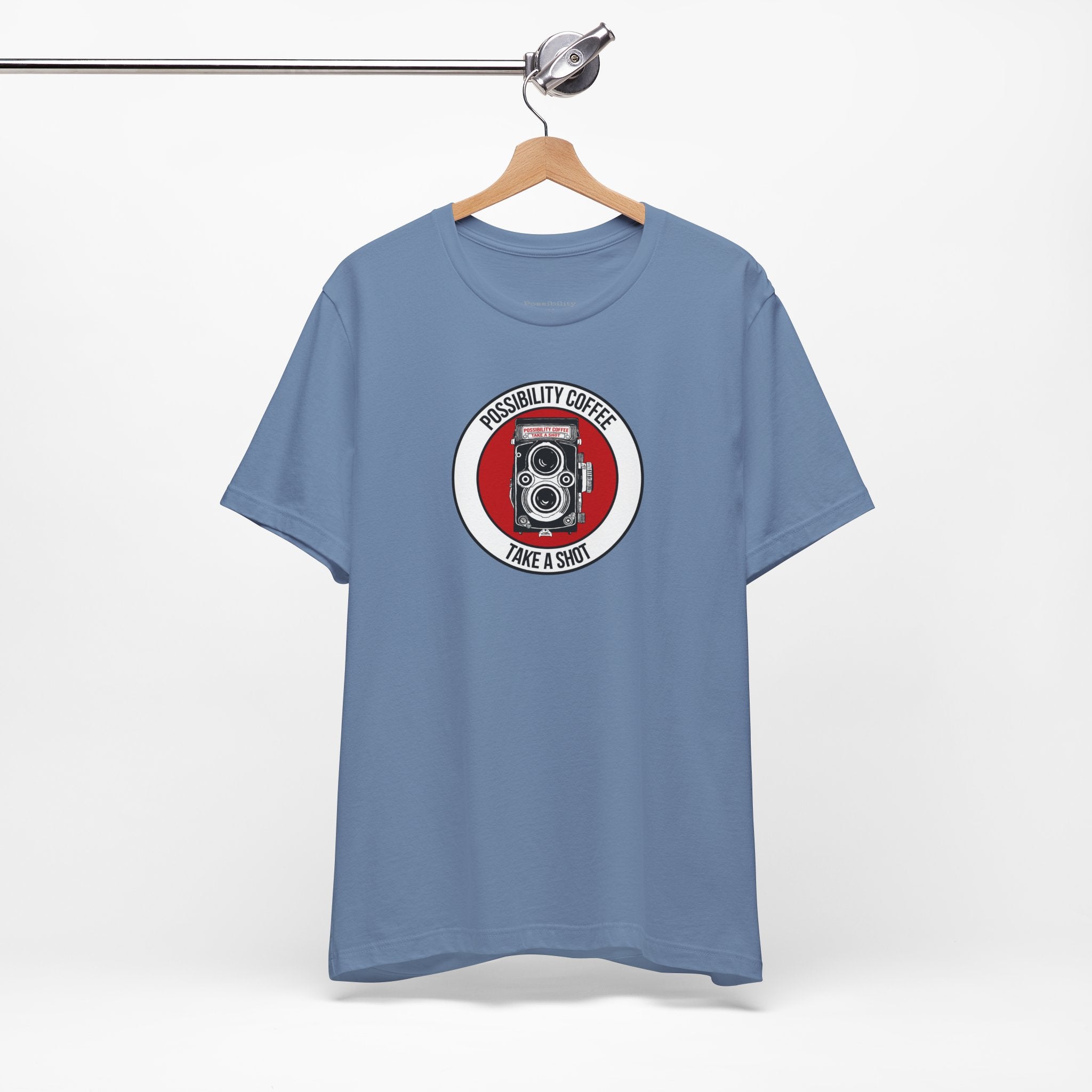 Blue t-shirt with a graphic design on a hanger against a white background