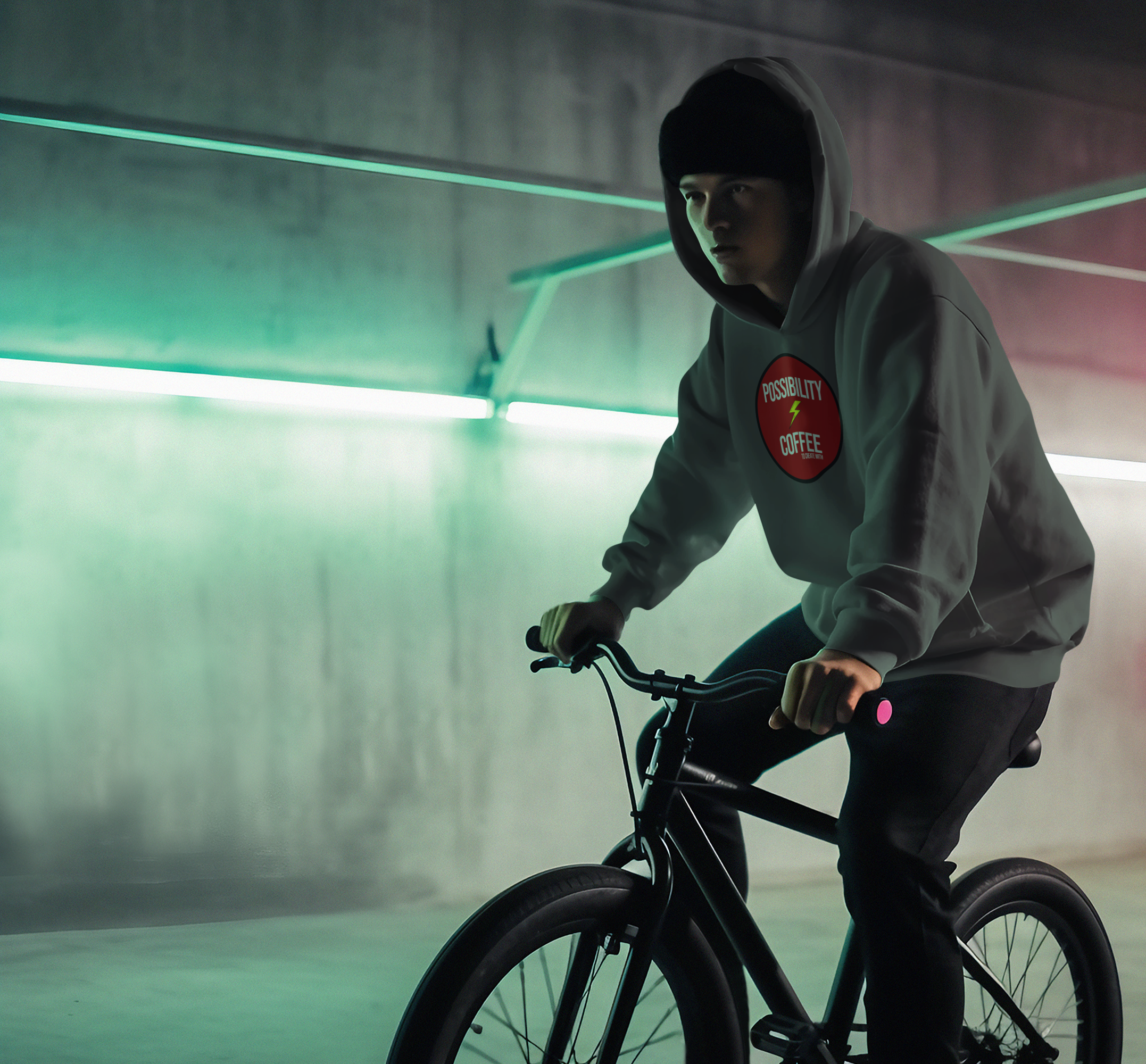 Man on bike wearing Possibility Coffee Hoodie